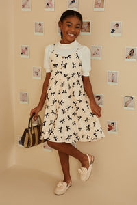 GY9196 Ivory Girls Bow Print Button Detail Tiered Tank Dress Pose